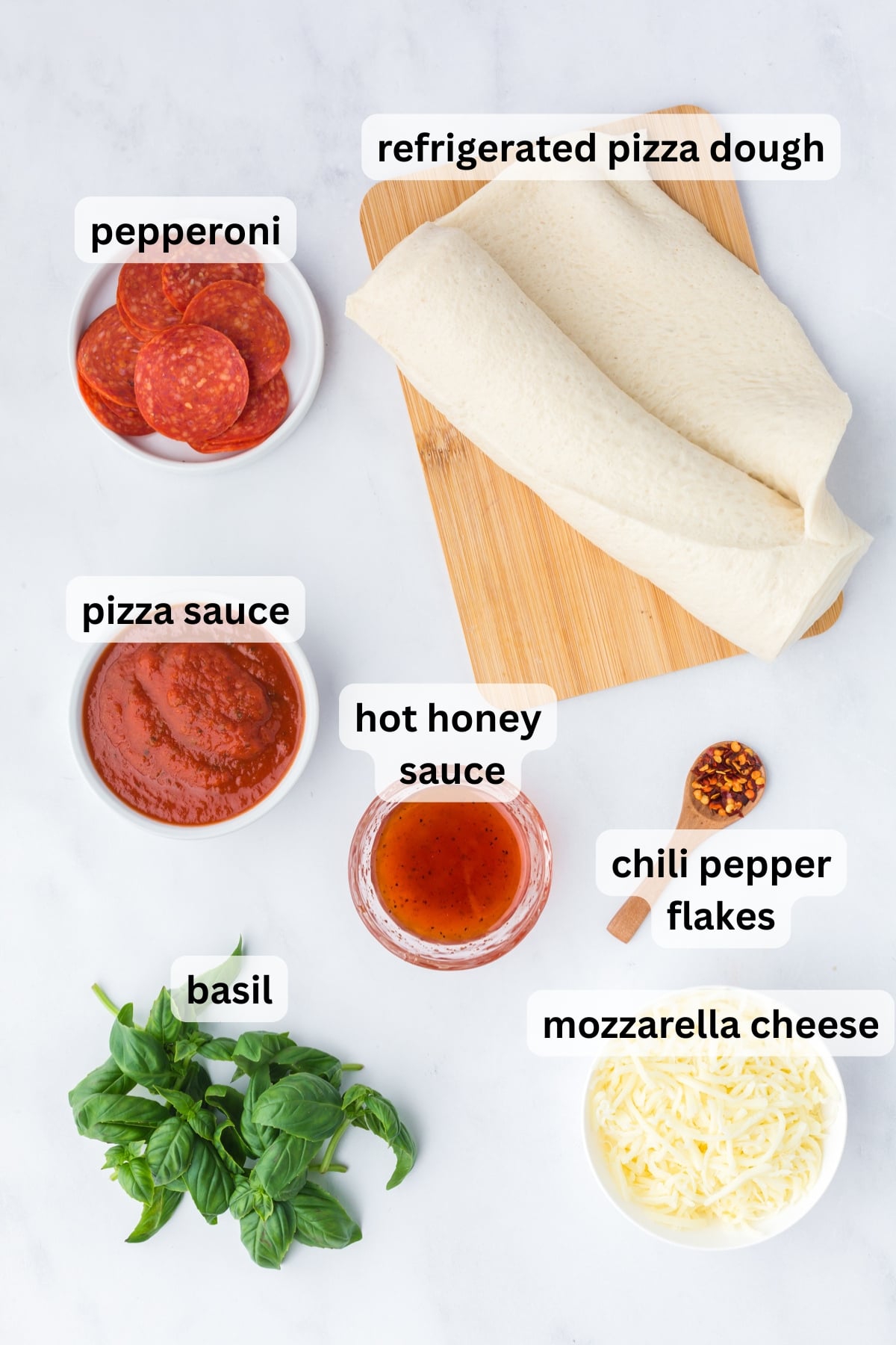All of the ingredients needed to make Hot Honey Pepperoni Pizza on a table.