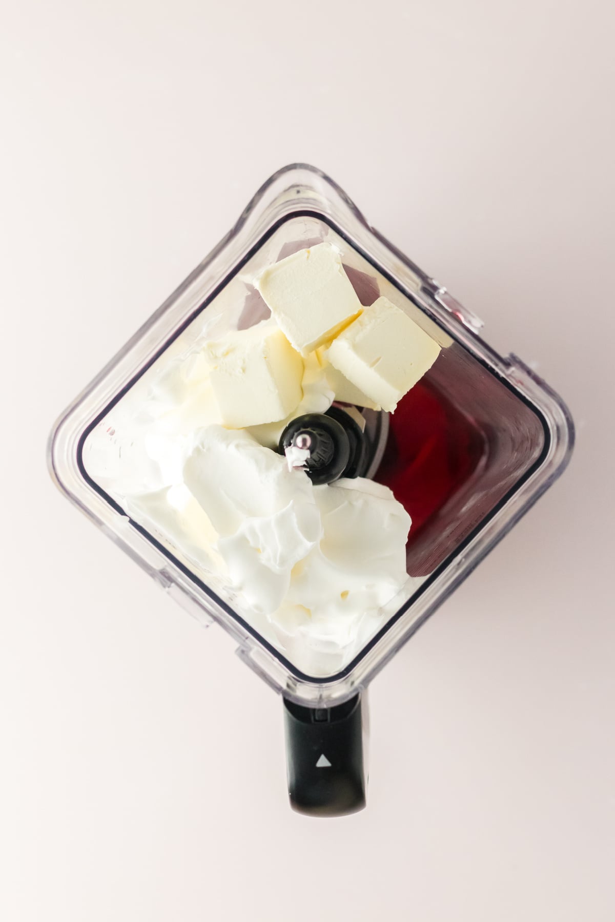 Jello, cream cheese and whipped topping in a blender ready to be blend.