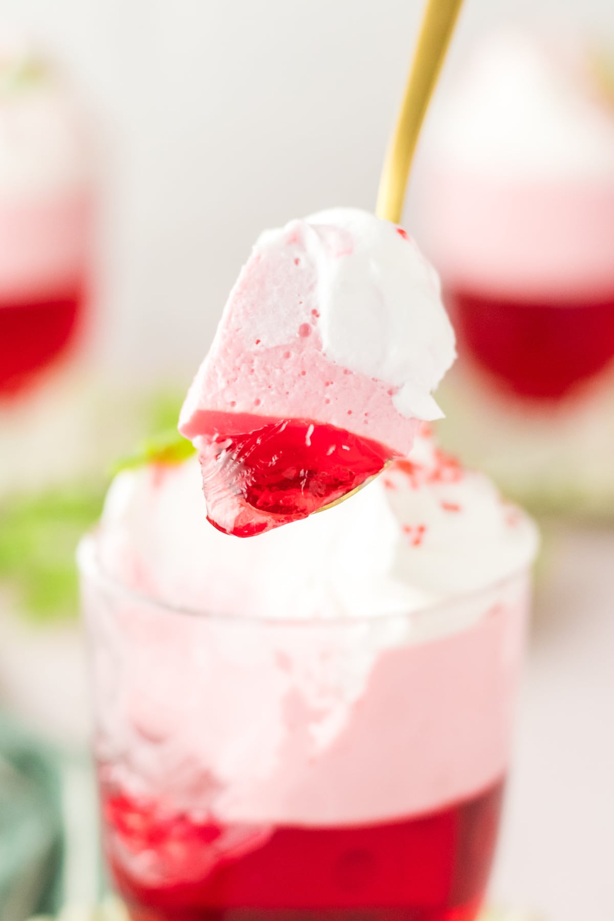 A layered spoonful held in the air.