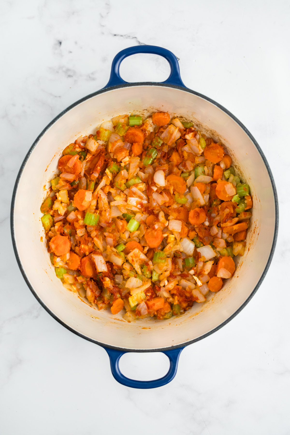 Tomato paste and flour added to the cooked vegetables. 