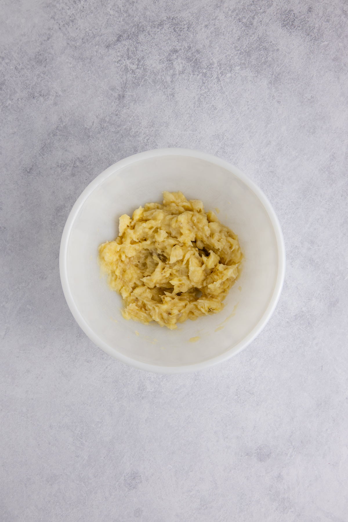 Bananas mashed in a bowl. 