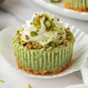 Pistachio cheesecake on a plate.