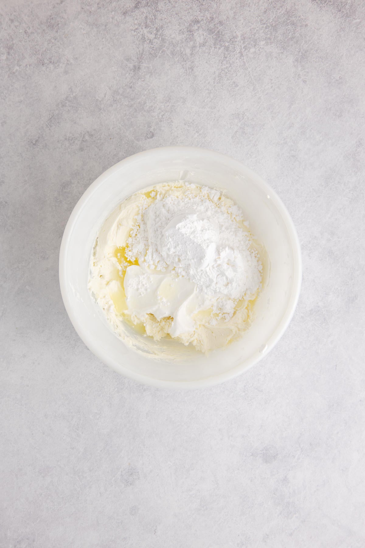 beaten cream cheese with Cool Whip, powdered sugar and lemon juice added waiting to be blended