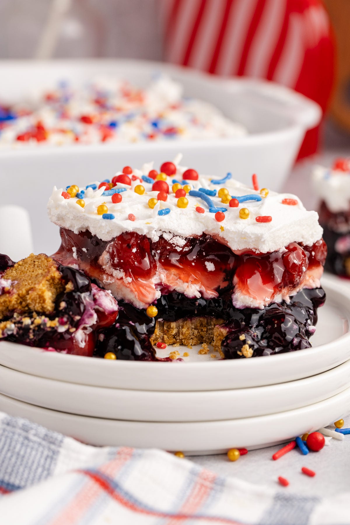 Red, White and Blue Berry Dessert on a plate missing a fork bite
