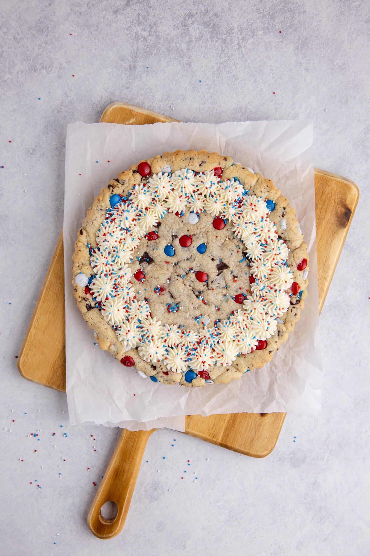 frosting added to cooled cake on parchment covered cutting board