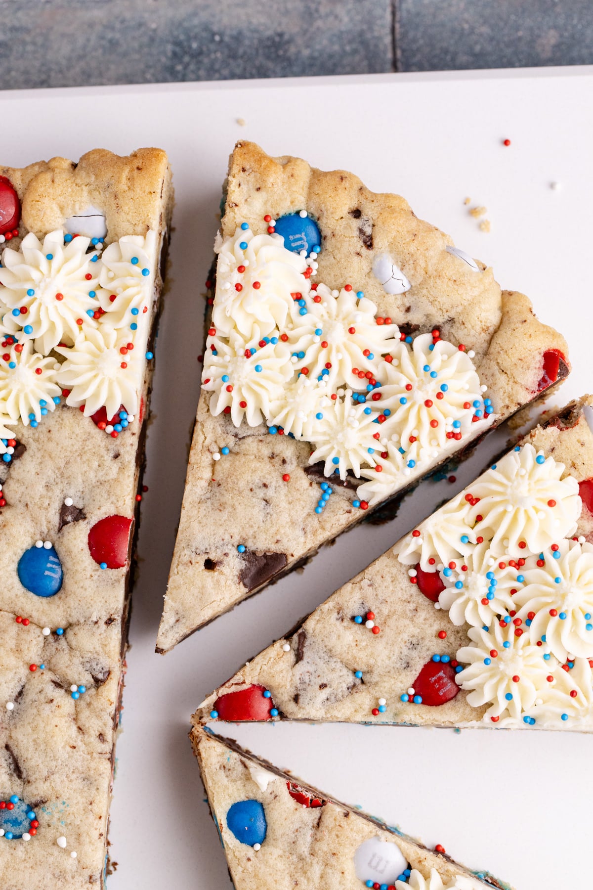 half of cookie cake sliced on a platter