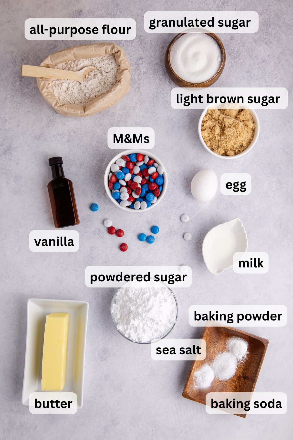 ingredients for red white and blue cookie cake including flour butter sugar eggs and m&ms in bowls on a table