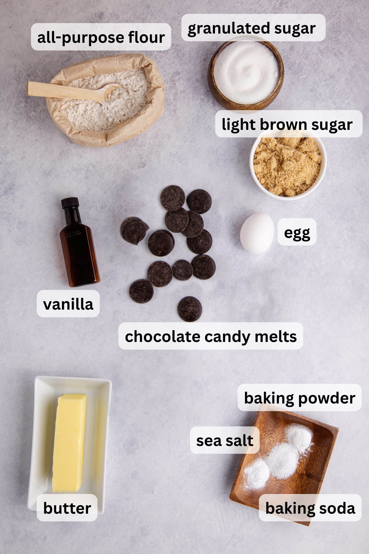 All of the ingredients needed to make a Sheet Pan Chocolate Chip Cookie in bowls on a table.