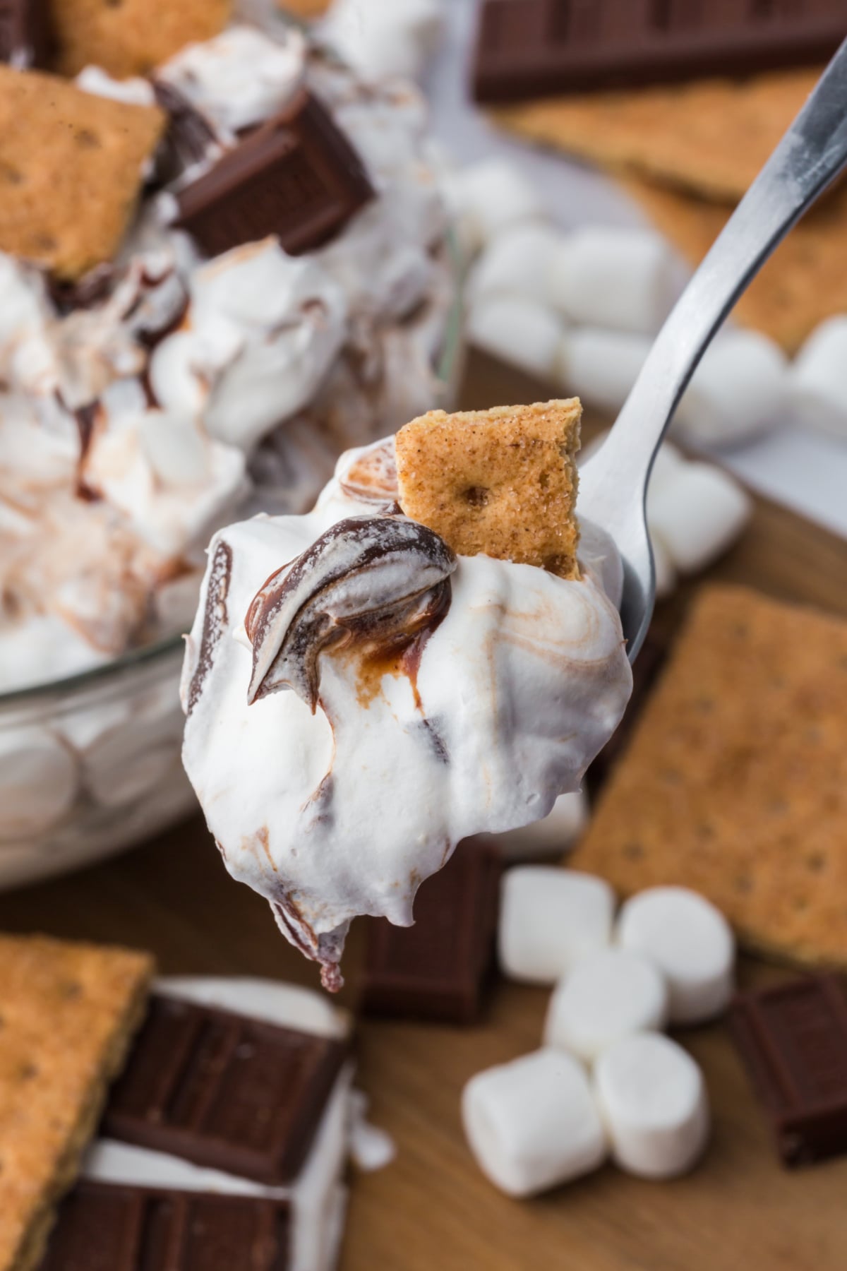 A spoonful of fluff held in the air in front of a bowlful.
