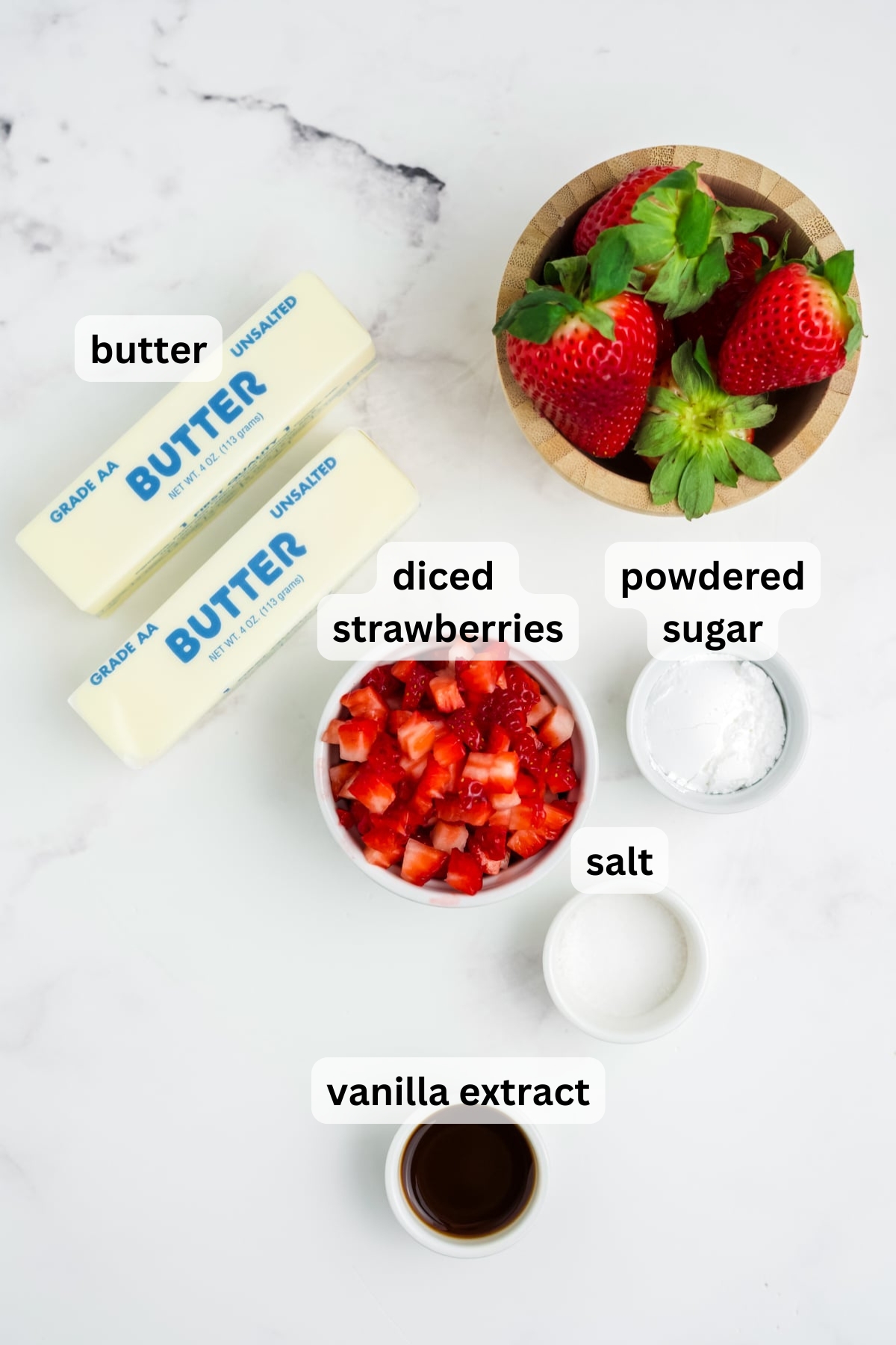 All of the ingredients needed to make Strawberry Butter in bowls on a table.