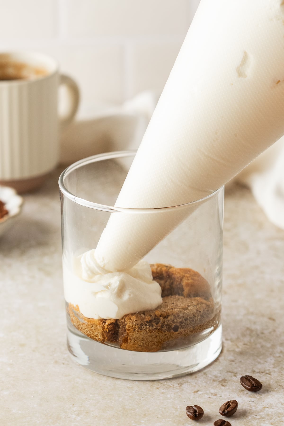 The mascarpone filling being piped into the cup.