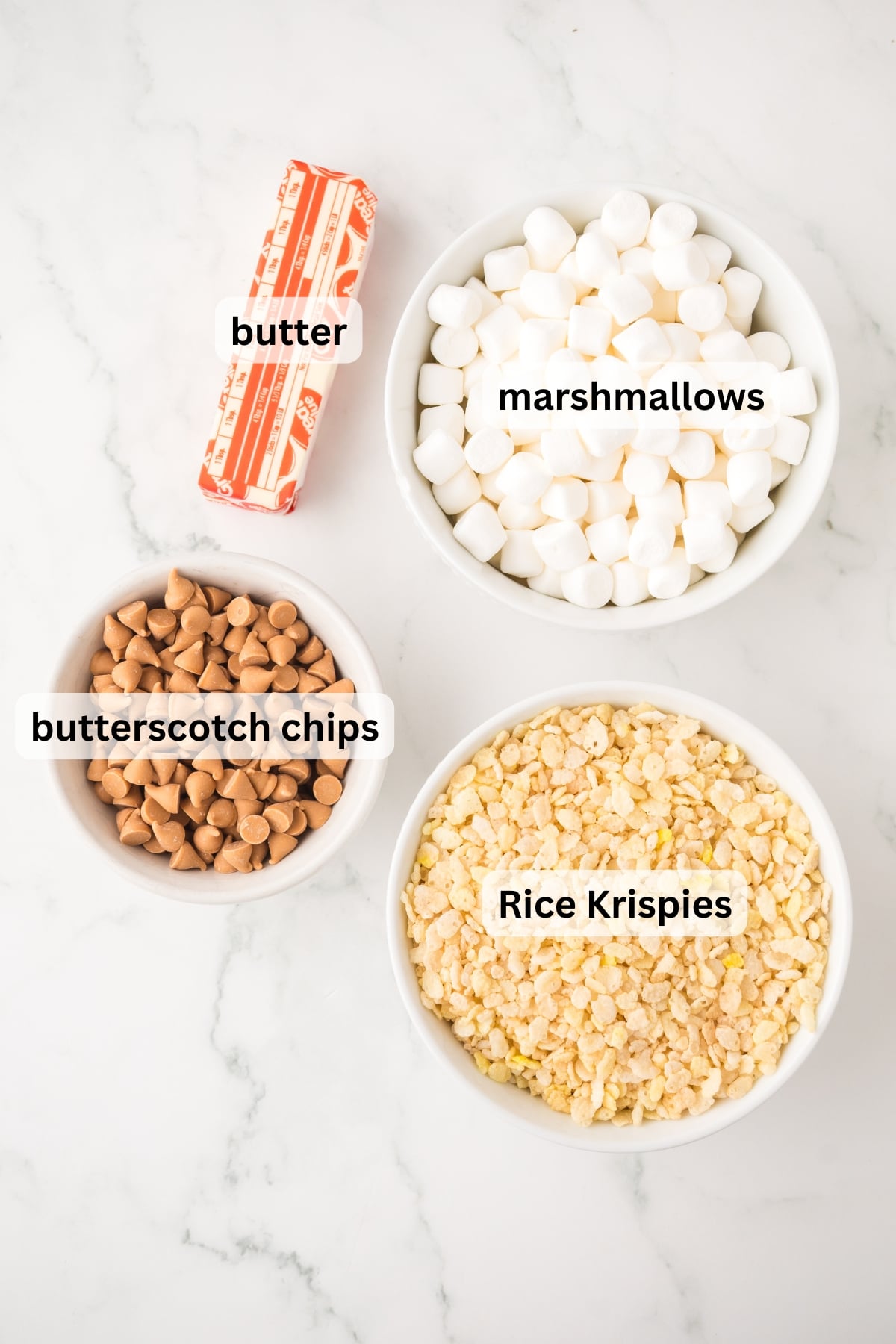All of the ingredients needed to make Butterscotch Rice Krispie Treats in bowls on a table