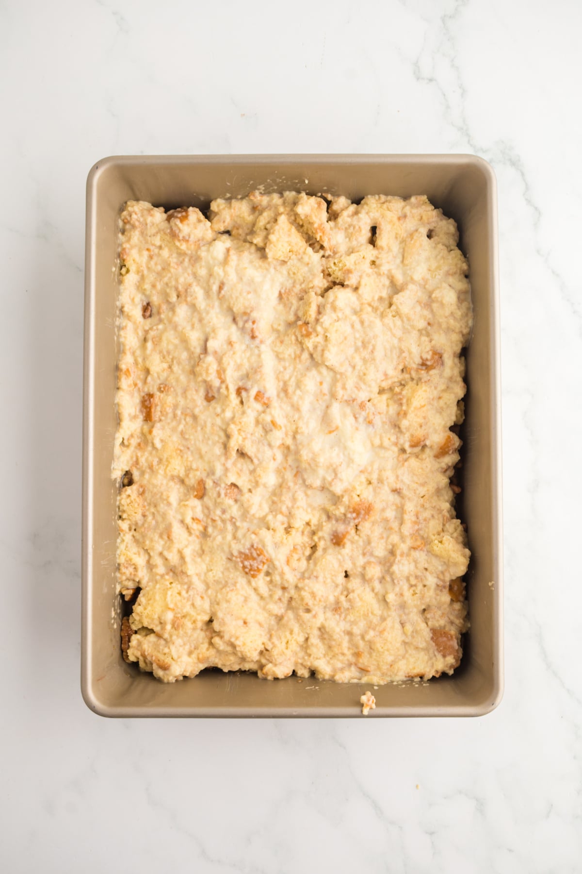 The bread pudding in a pan to bake.