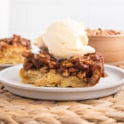 Pecan bread pudding with vanilla ice cream on top.
