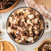 chocolate peanut butter popcorn coated snack mix in bowl on table