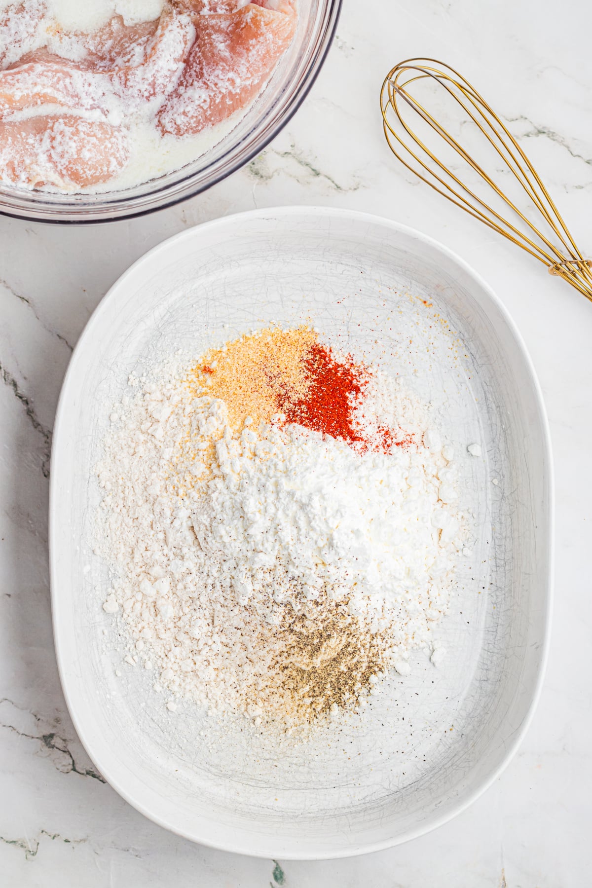 Flour, cornstarch, and spices in a shallow dish