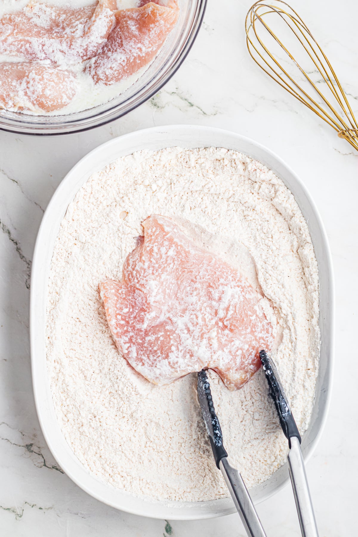 Chicken coated in the flour mixture.