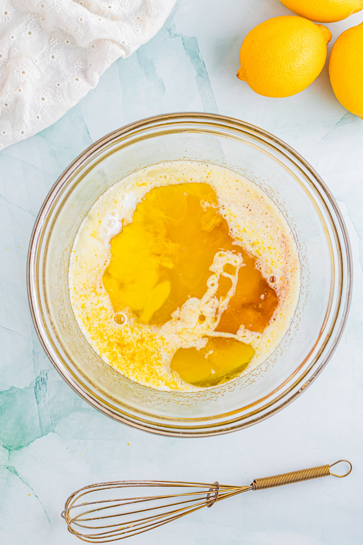 Oil, lemon juice/zest, milk, and vanilla added to the bowl.