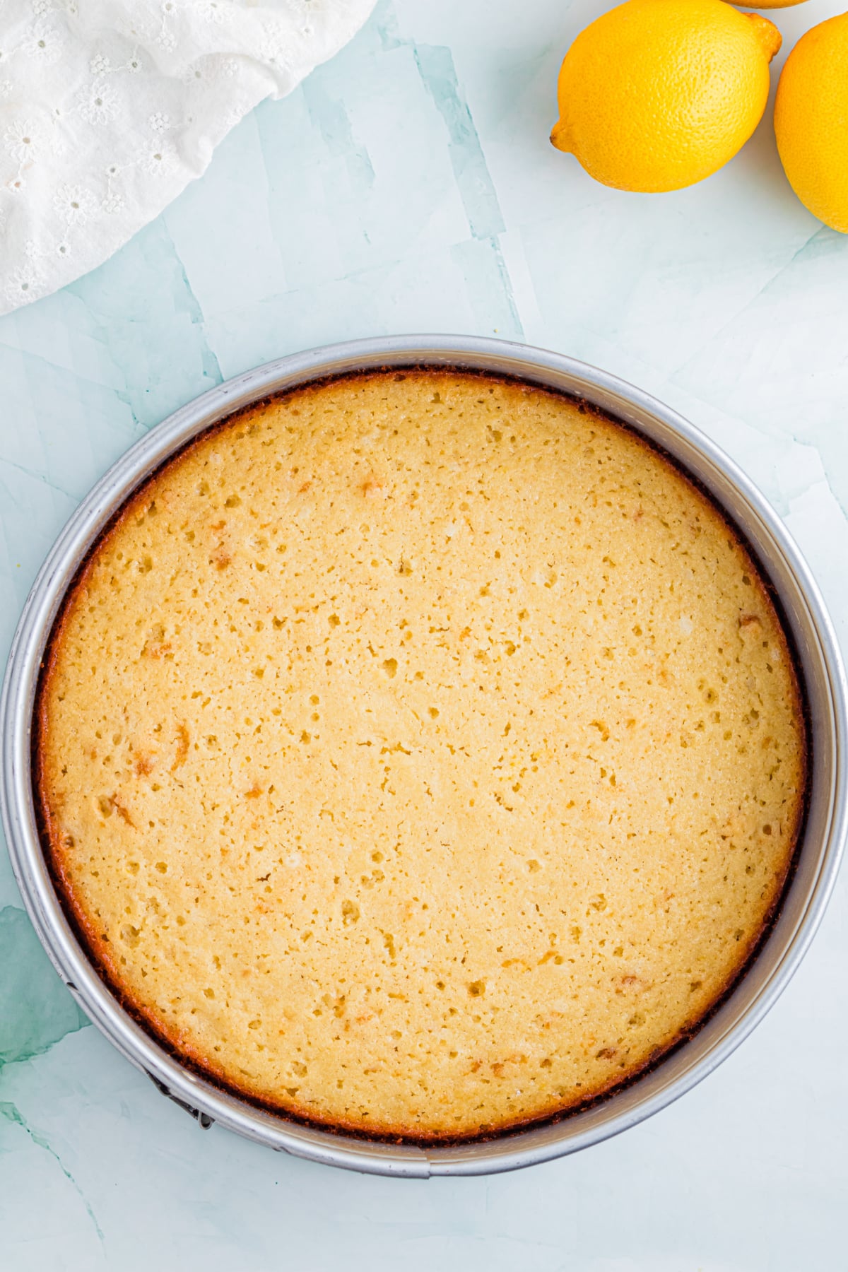 The cake baked and cooling in the cake pan.