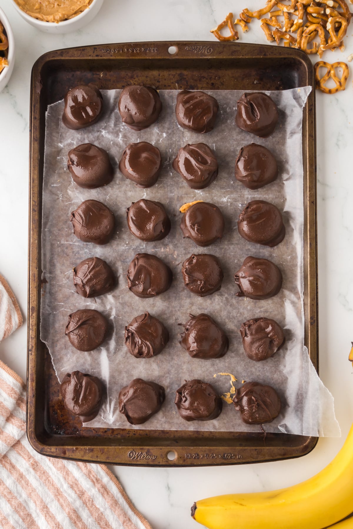 Dipped bites on a parchment covered cookie sheet ready to chill