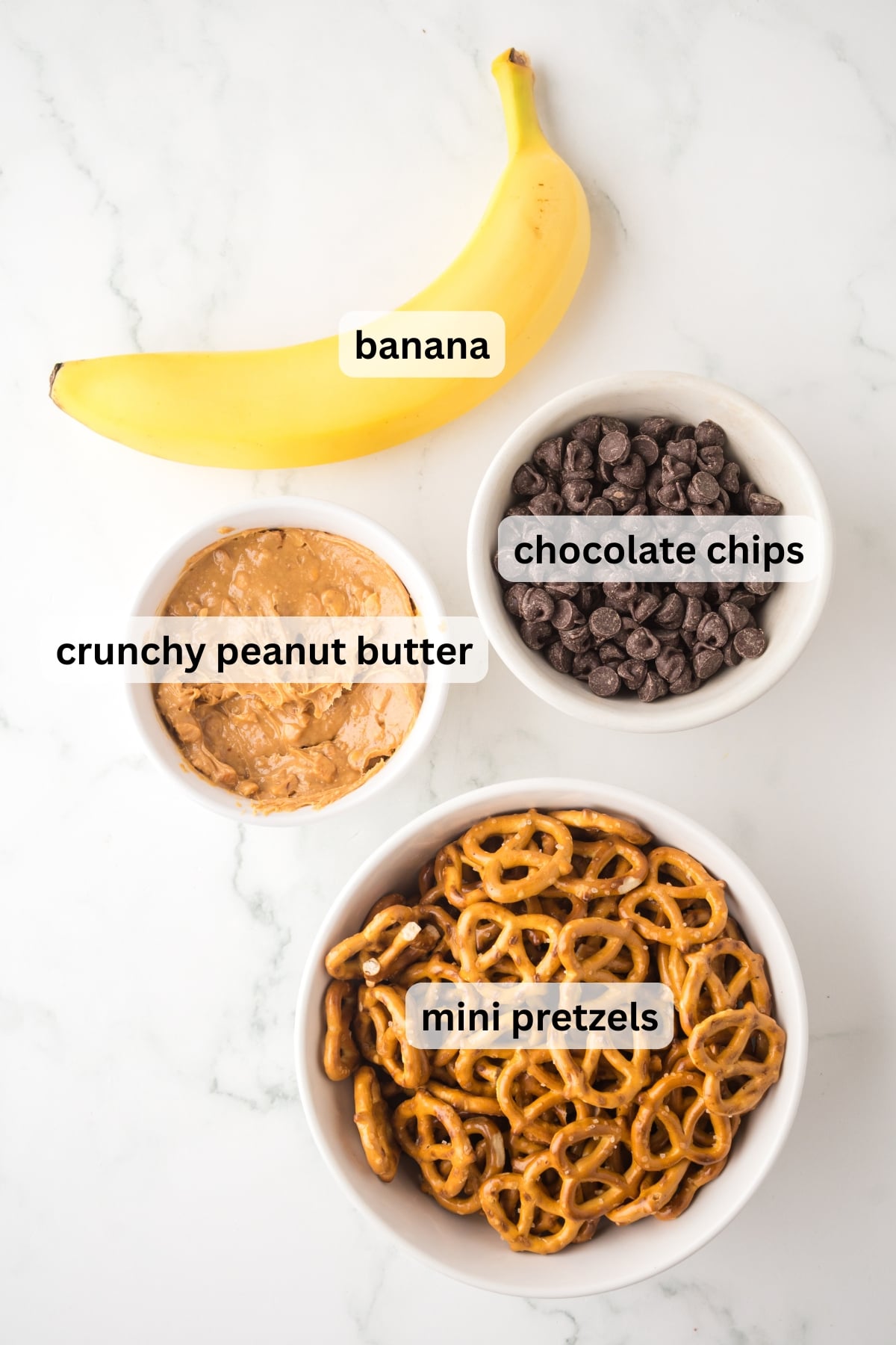 All of the ingredients needed to make Peanut Butter Pretzel Bites on a table in bowls