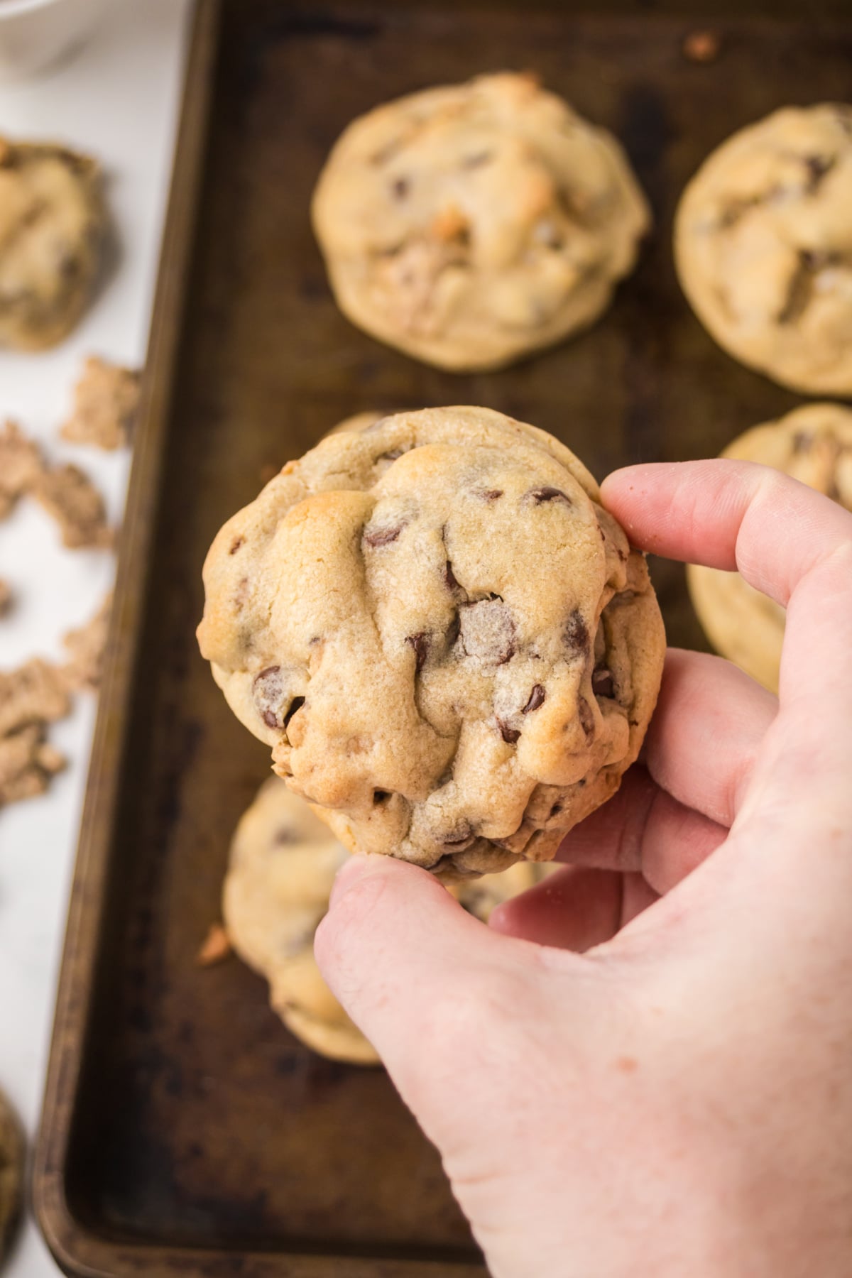 A s'mores cookie being held up in the air.