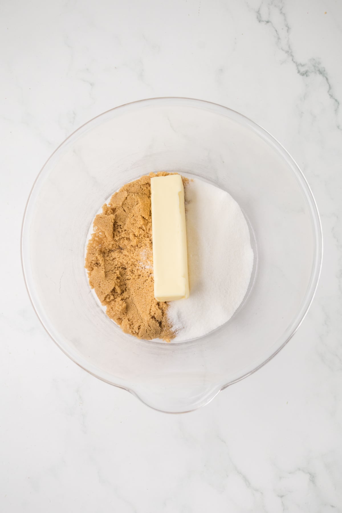 Butter and sugars in a mixing bowl.