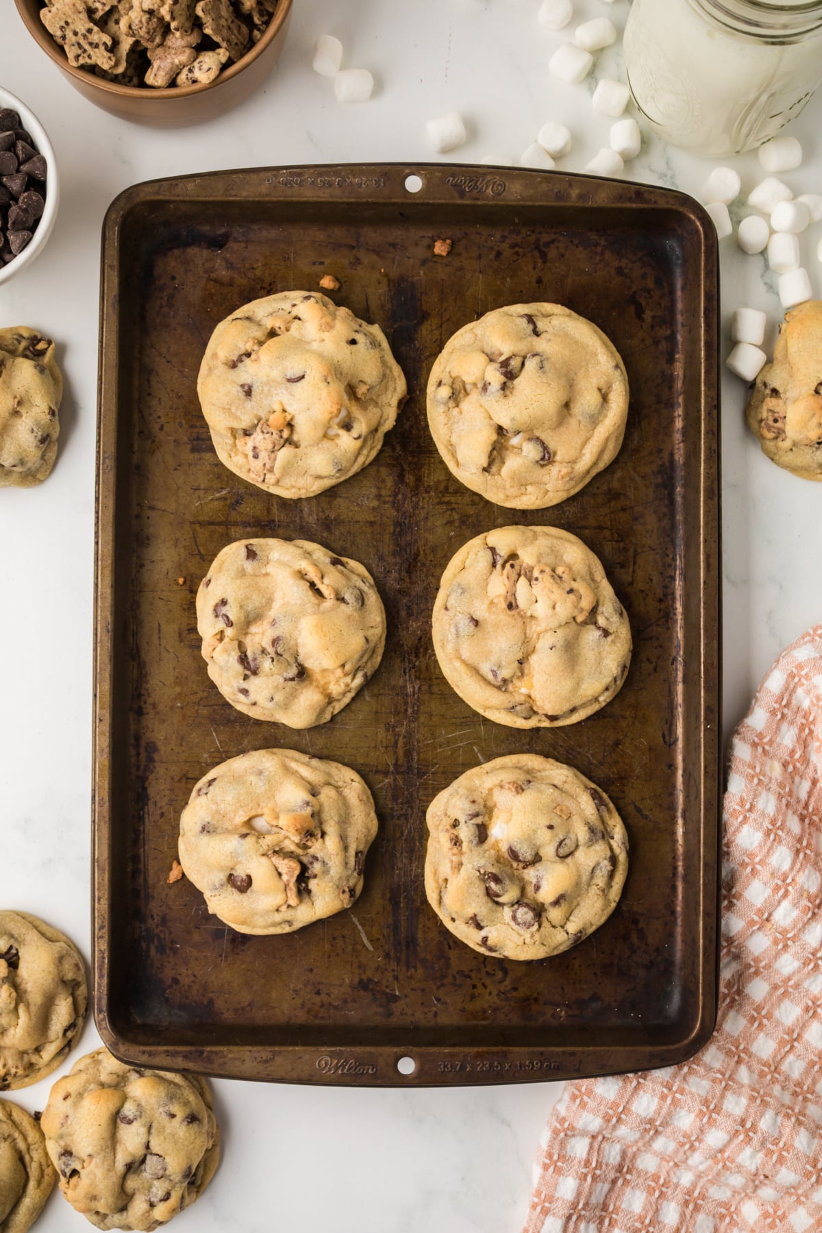 The cookies cooked and cooling on the baking sheet.