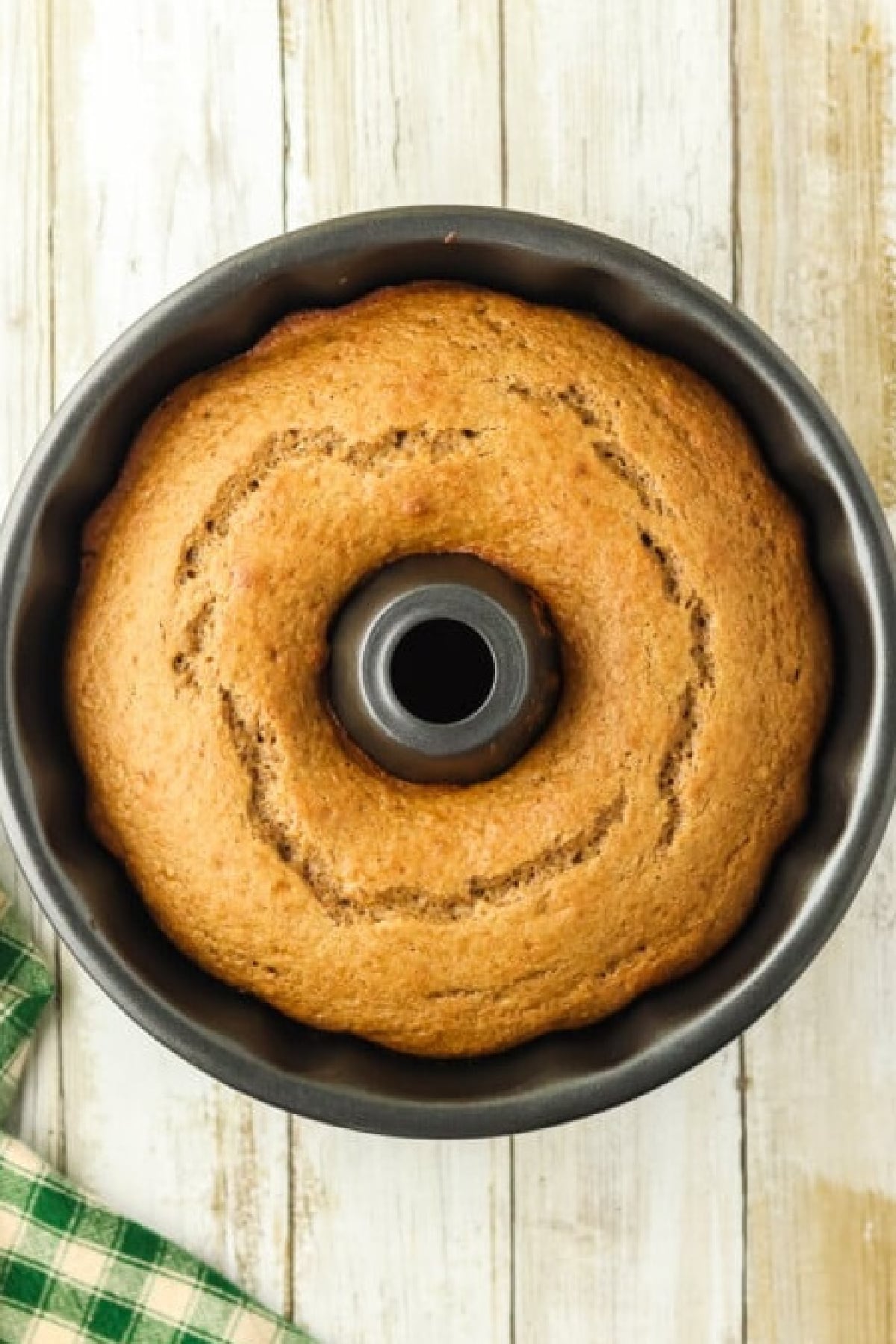 Freshly baked cake cooling in a bundt pan.