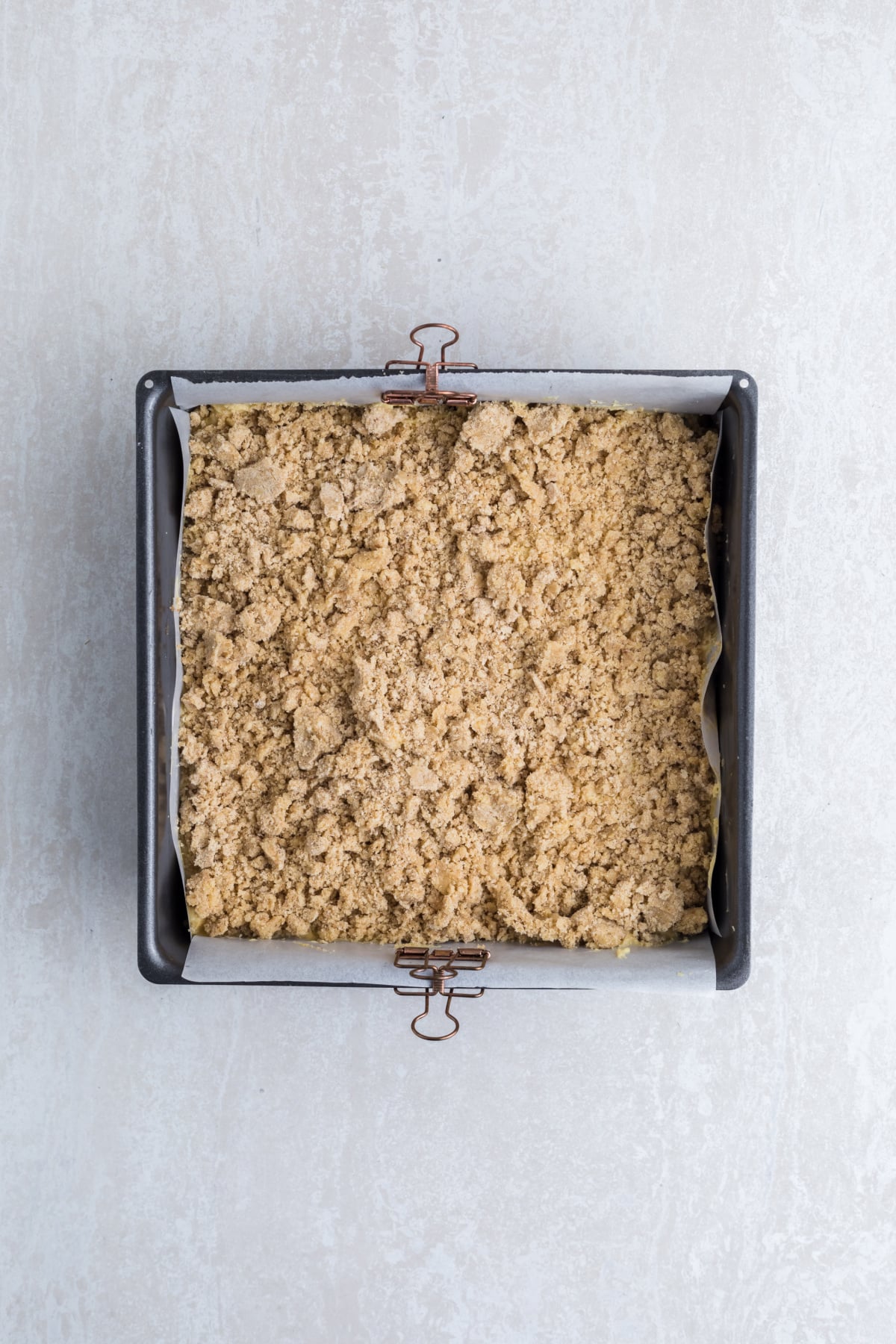 Remaining cake batter spread on apples followed by crumb topping.
