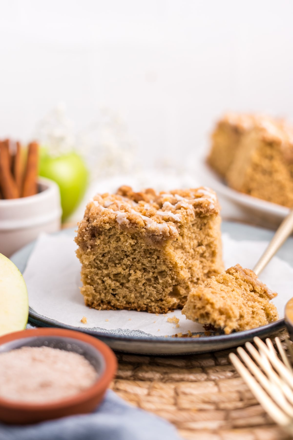 A slice of cake on a plate with a bite on a fork.