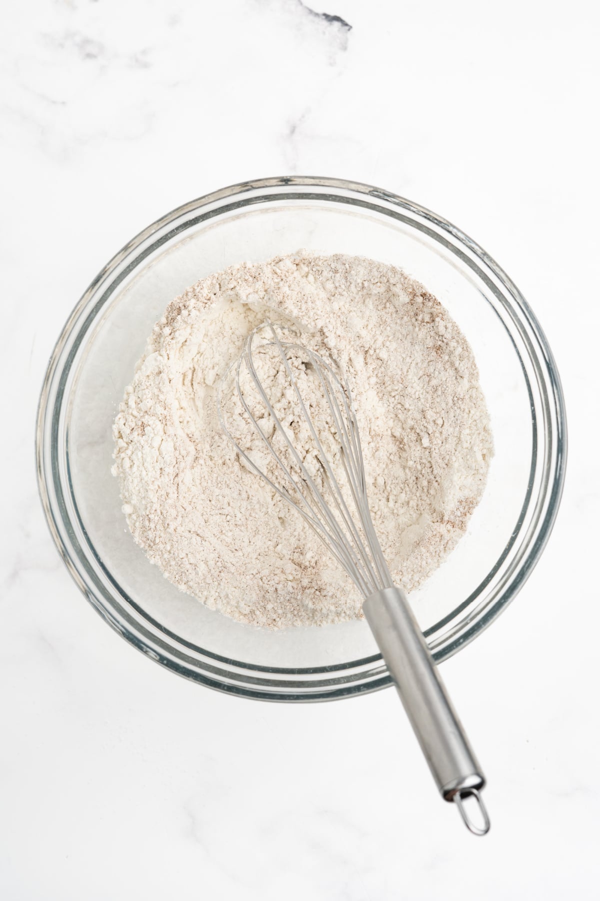 All of the dry ingredients blended in a bowl with a whisk.
