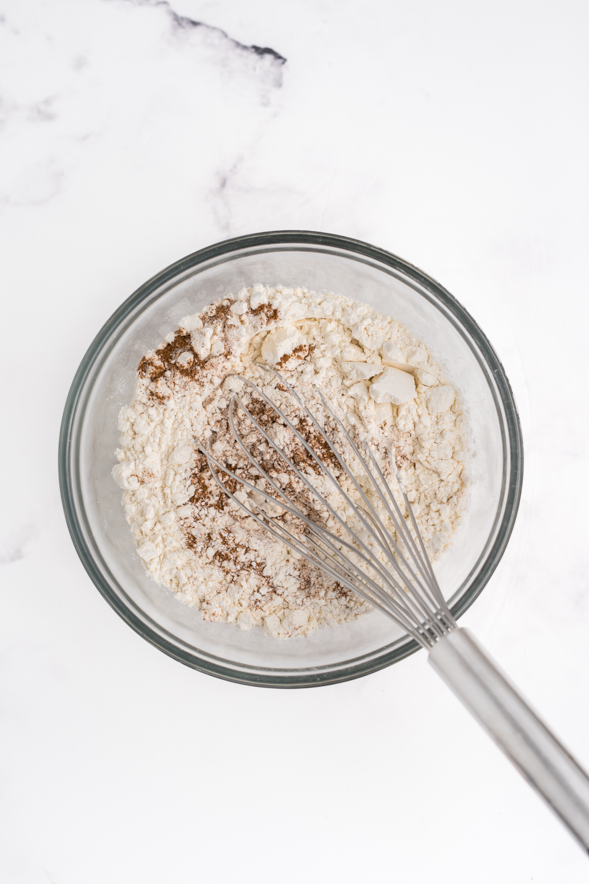 Dry ingredients being whisked in mixing bowl.