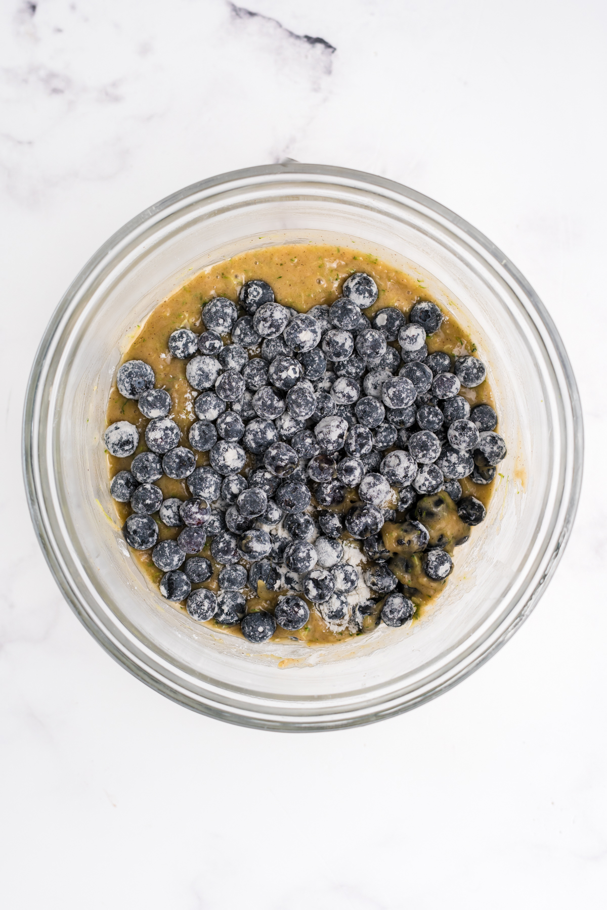 Coated blueberries added to batter.