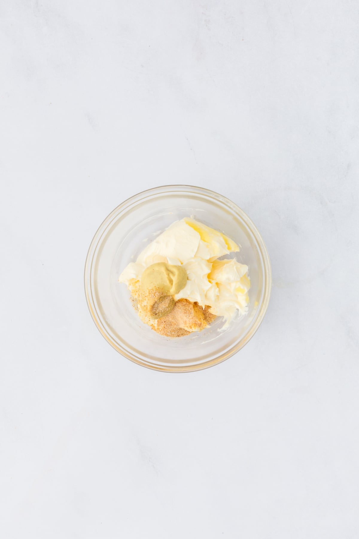 A small bowl filled with butter, dijon, and garlic powder.