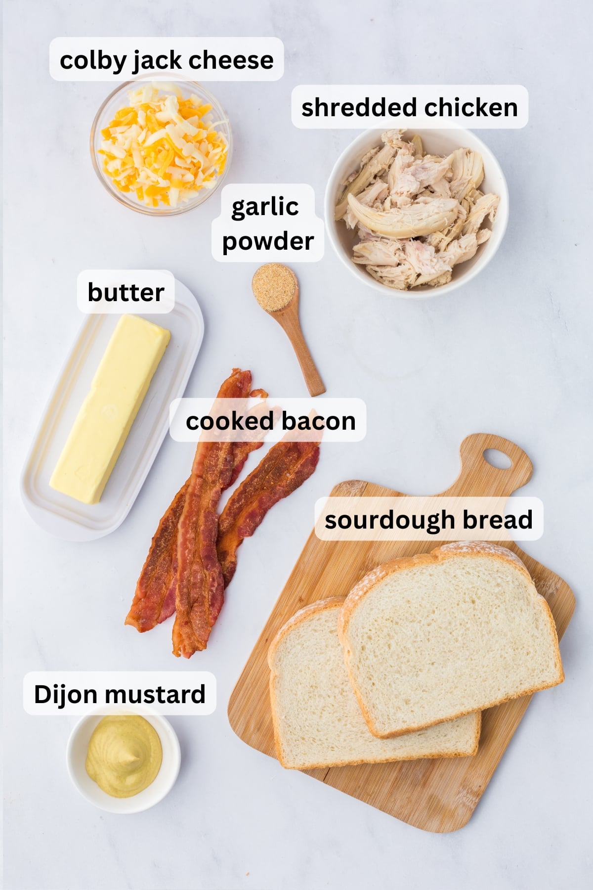 All of the ingredients needed to make Chicken Grilled Cheese in bowls on a table.
