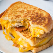 Two halves of Chicken Grilled Cheese stacked on a plate.