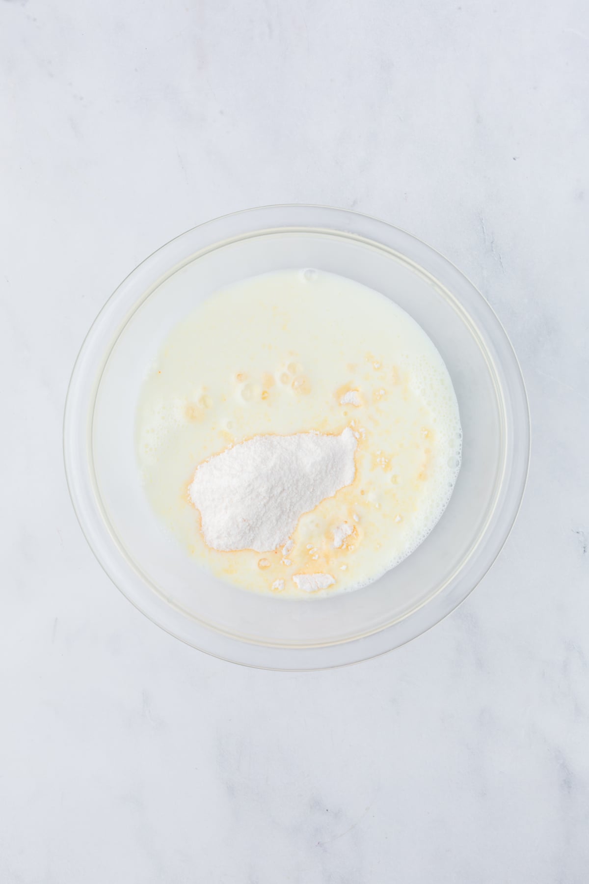 cheesecake pudding powder and milk in a bowl.