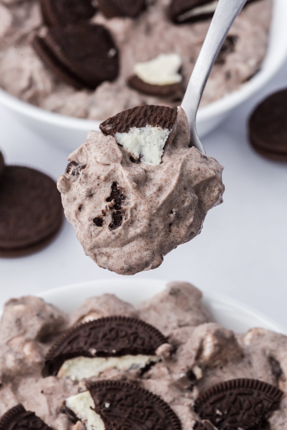 A spoonful of fluff held in the air above a bowlful.