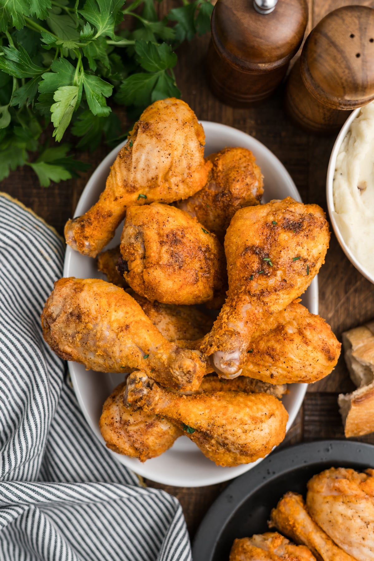 A bowl filled with crispy chicken drumsticks.