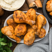 Crispy baked chicken drumsticks on a plate.