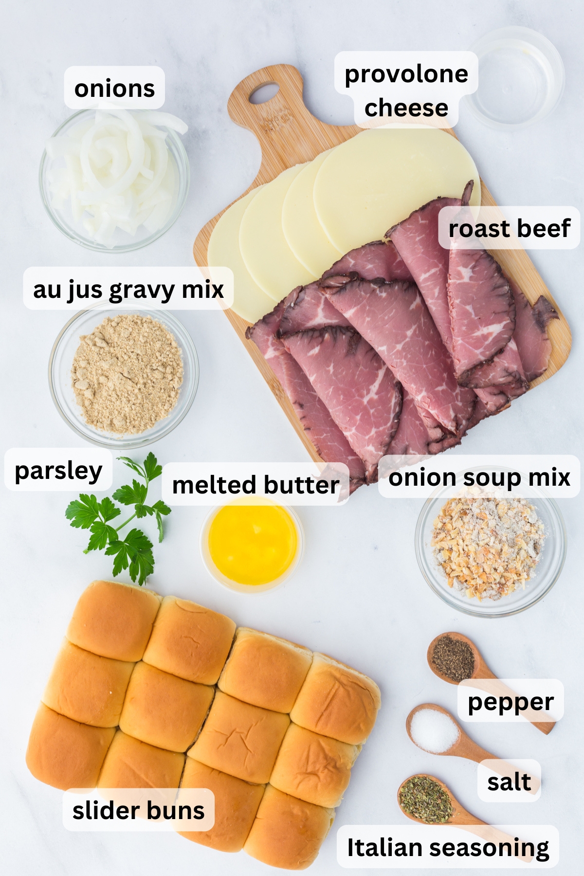 All of the ingredients needed to make French dip sliders in bowls on a table.
