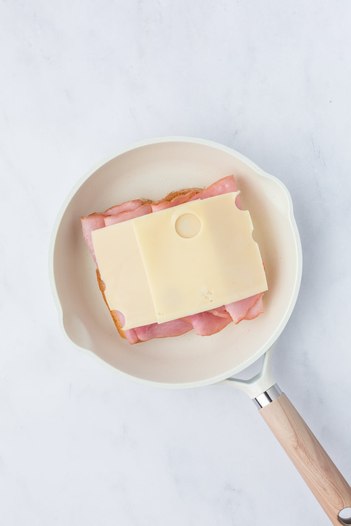 Ham and swiss cheese on top of cheddar,
