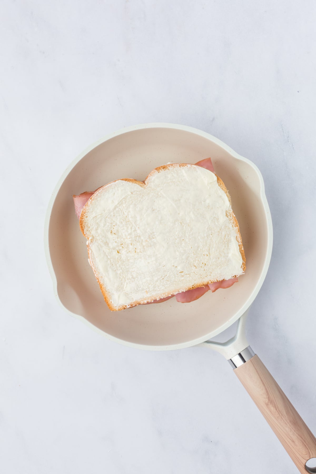 Buttered side up bread added on top.