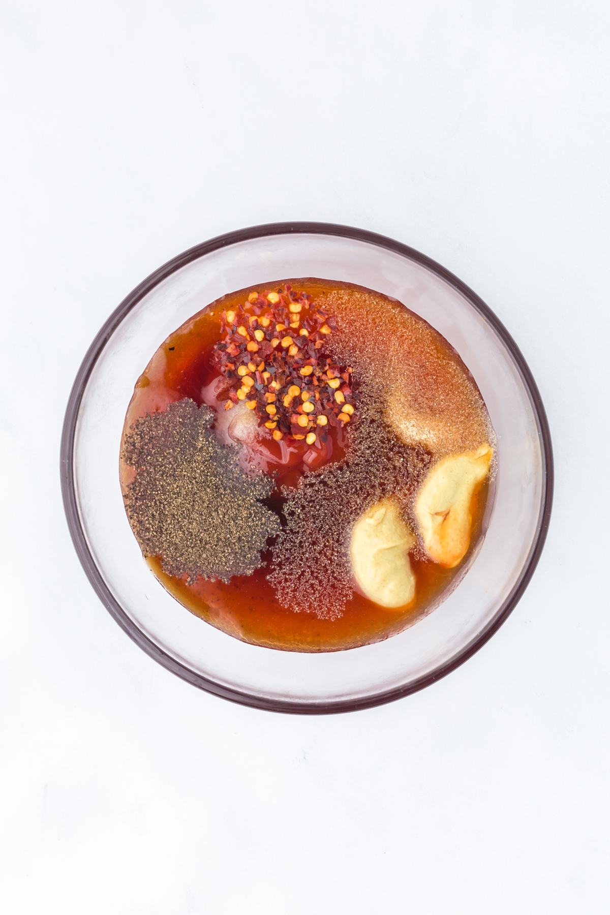 BBQ sauce ingredients in a mixing bowl before whisking.