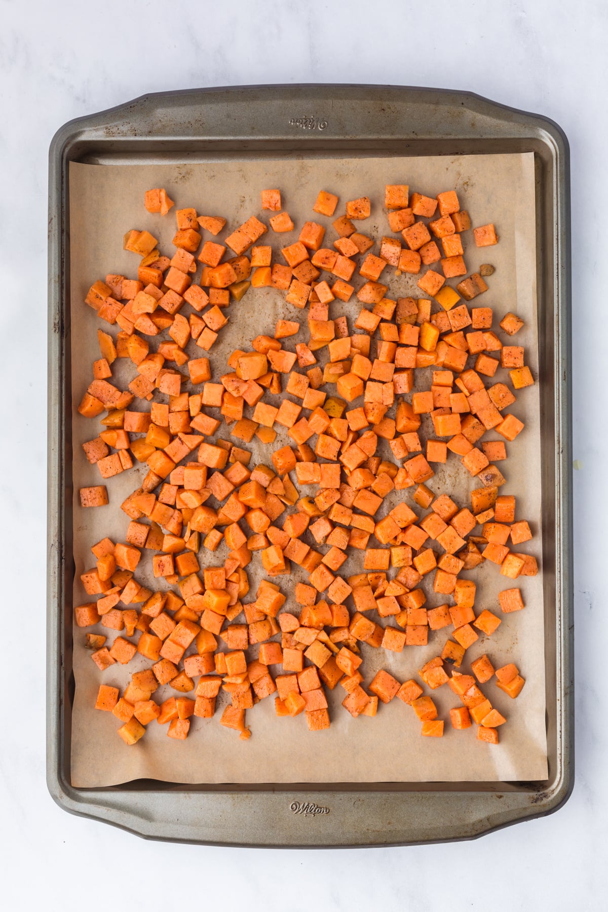 Roasted sweet potatoes on a baking sheet.