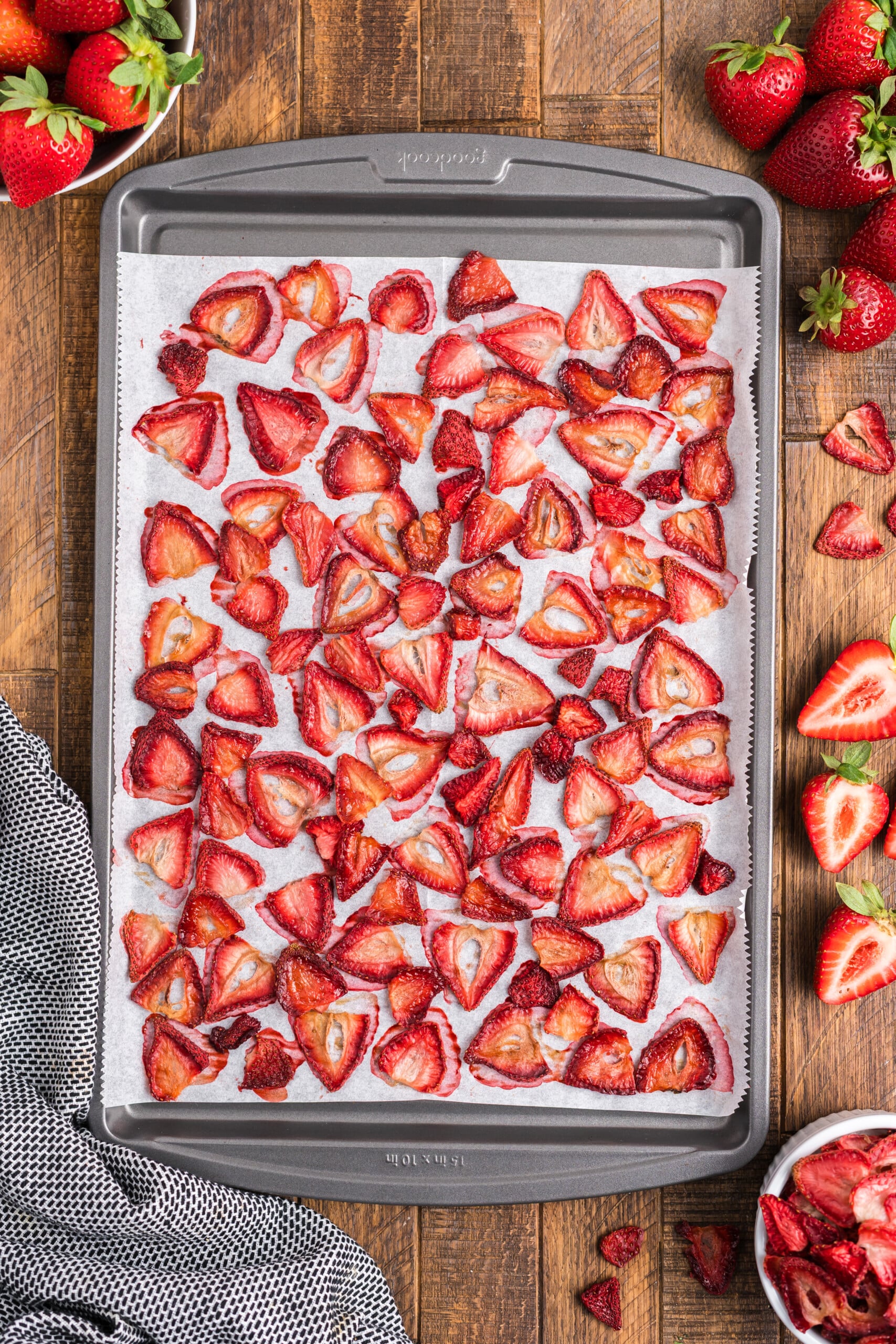 The baked strawberries cooling on a baking sheet.