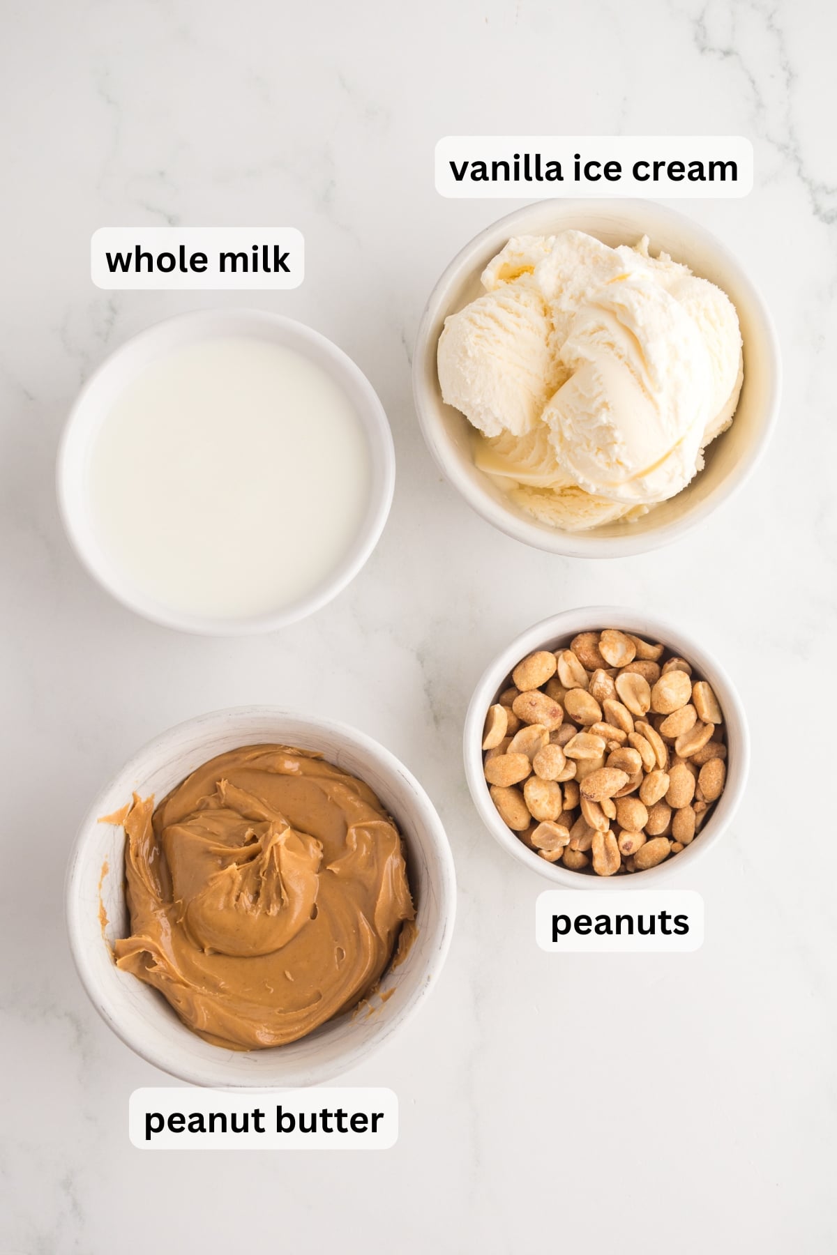 all of the ingredients needed to make a peanut butter milkshake in bowls on a table.