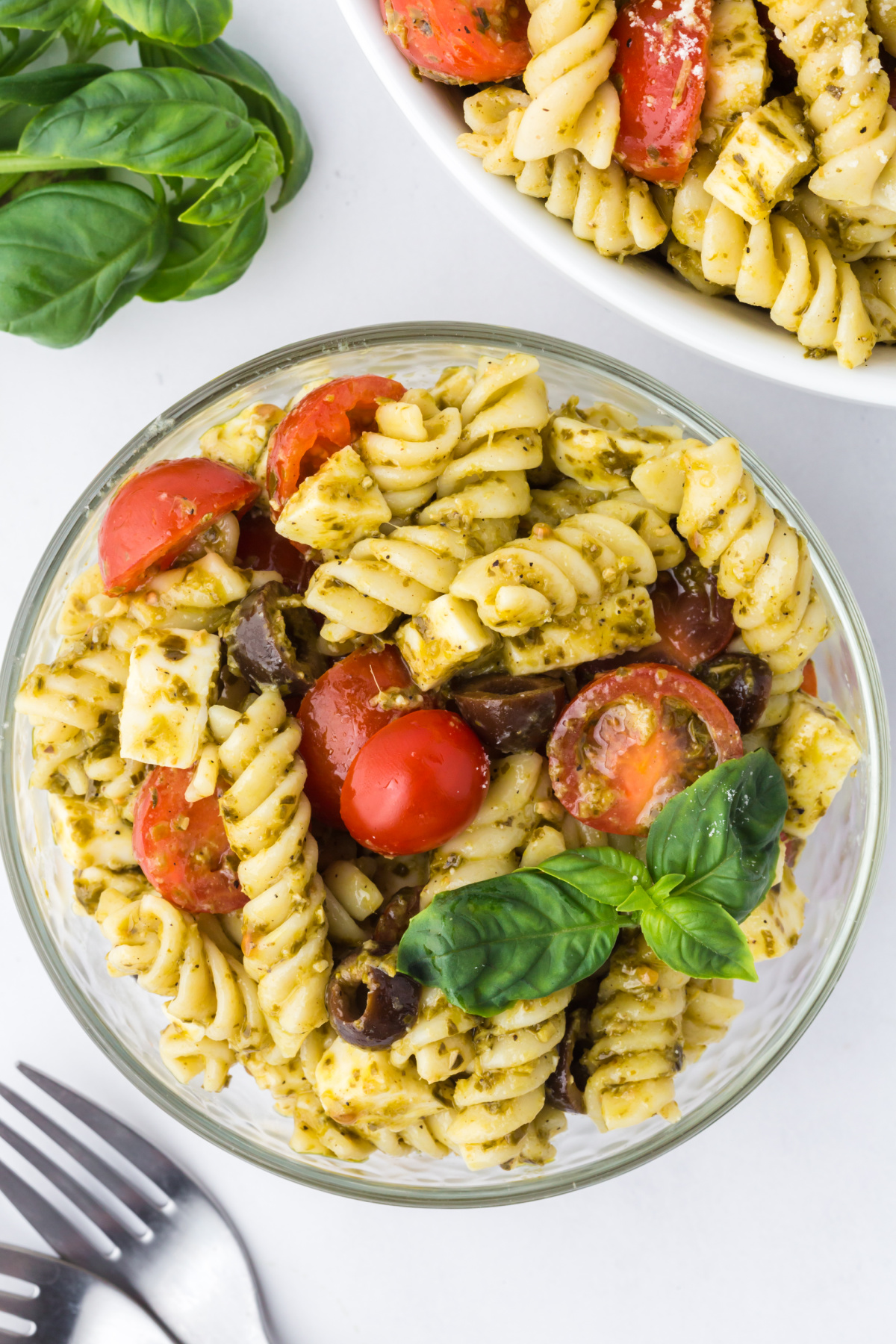 A bowlful of pasta Salad on a table.