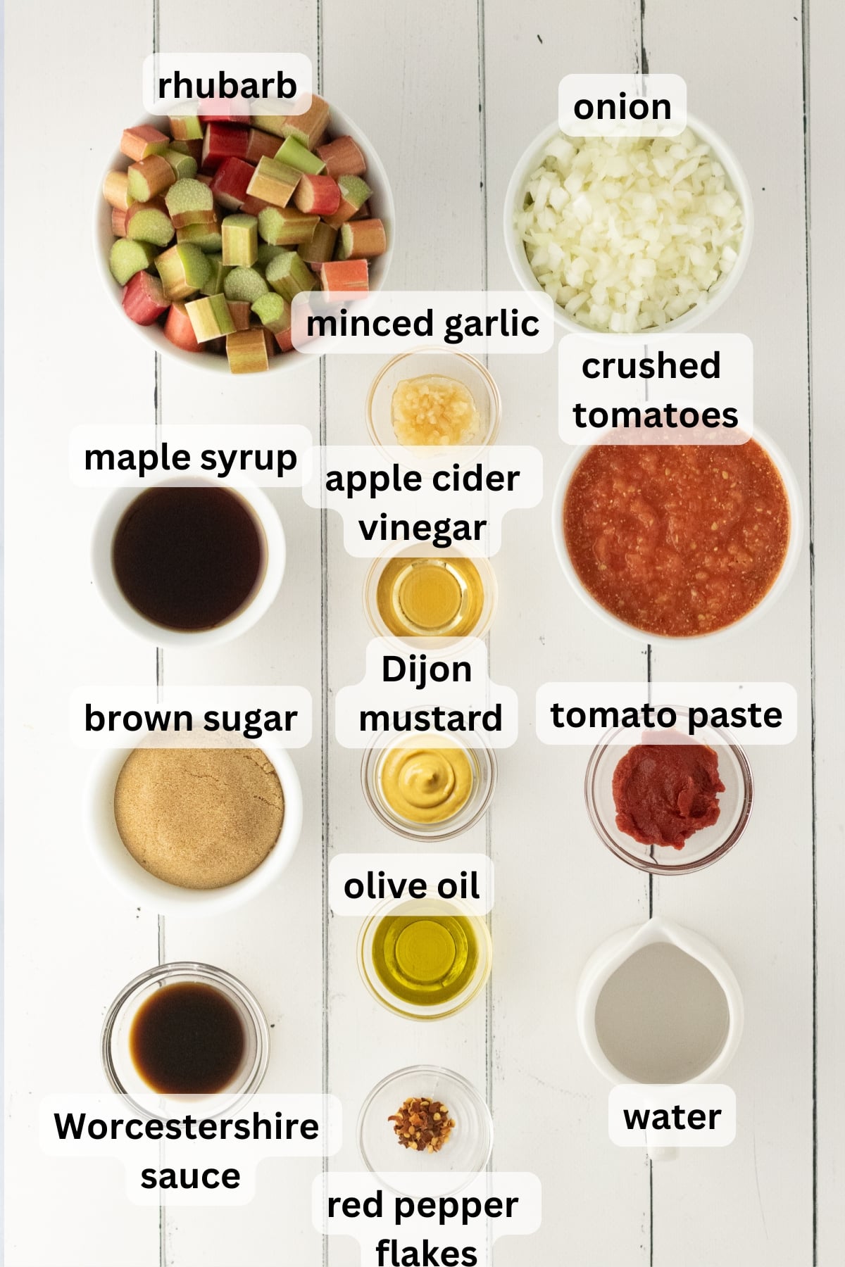All of the ingredients needed to make rhubarb bbq sauce in bowls on a table.